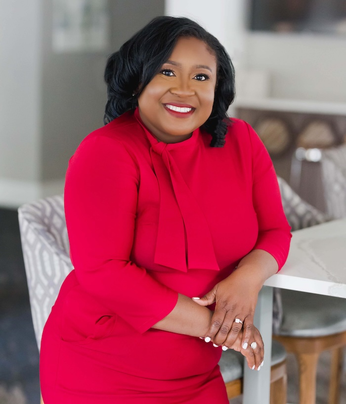 crystal wearing red dress and leaning against counter